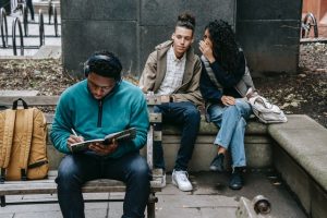 Listening to music from a headset sitting on a bench outdoors