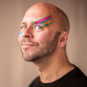 Man with colorful painted marks on his face